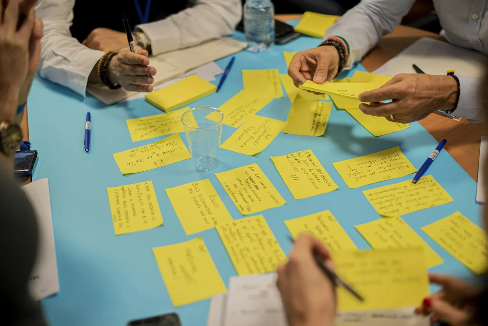 Equipe organizando post-its sobre a mesa